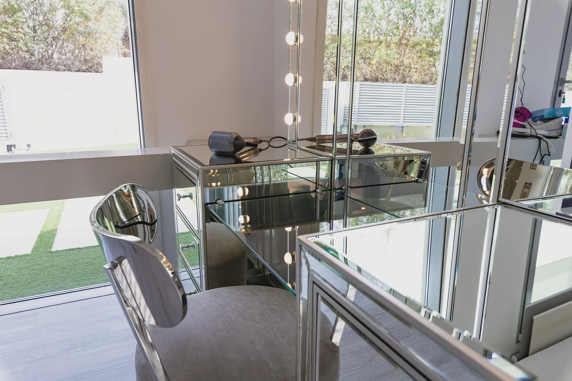 Parkway Vistas dressing area with mirrored vanity, Hollywood lights and garden view