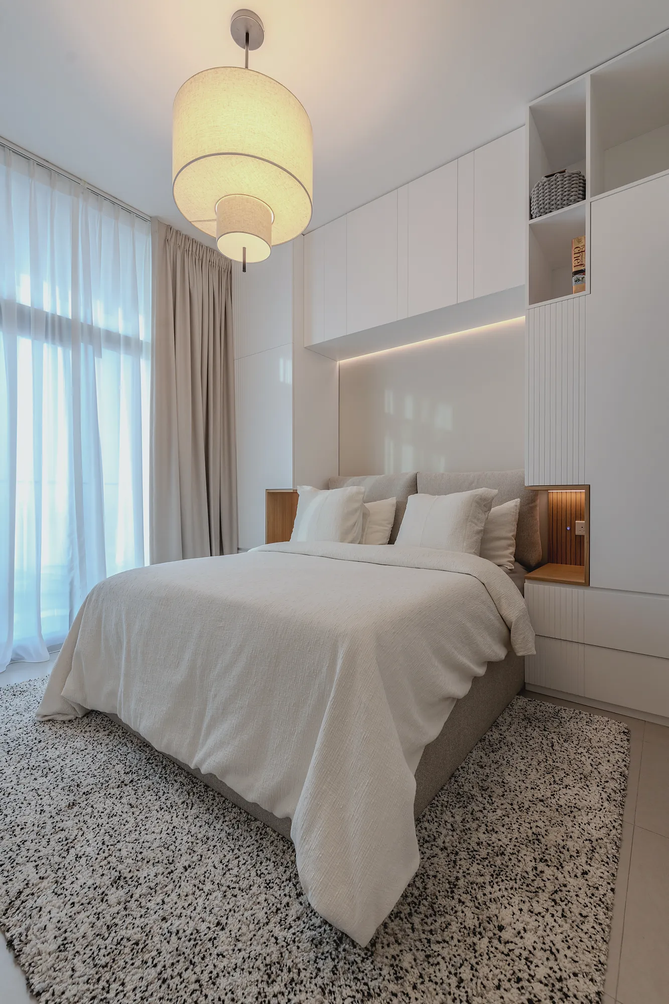 Prive 702 second bedroom with fluted wardrobes, lit oak niches and fabric pendant