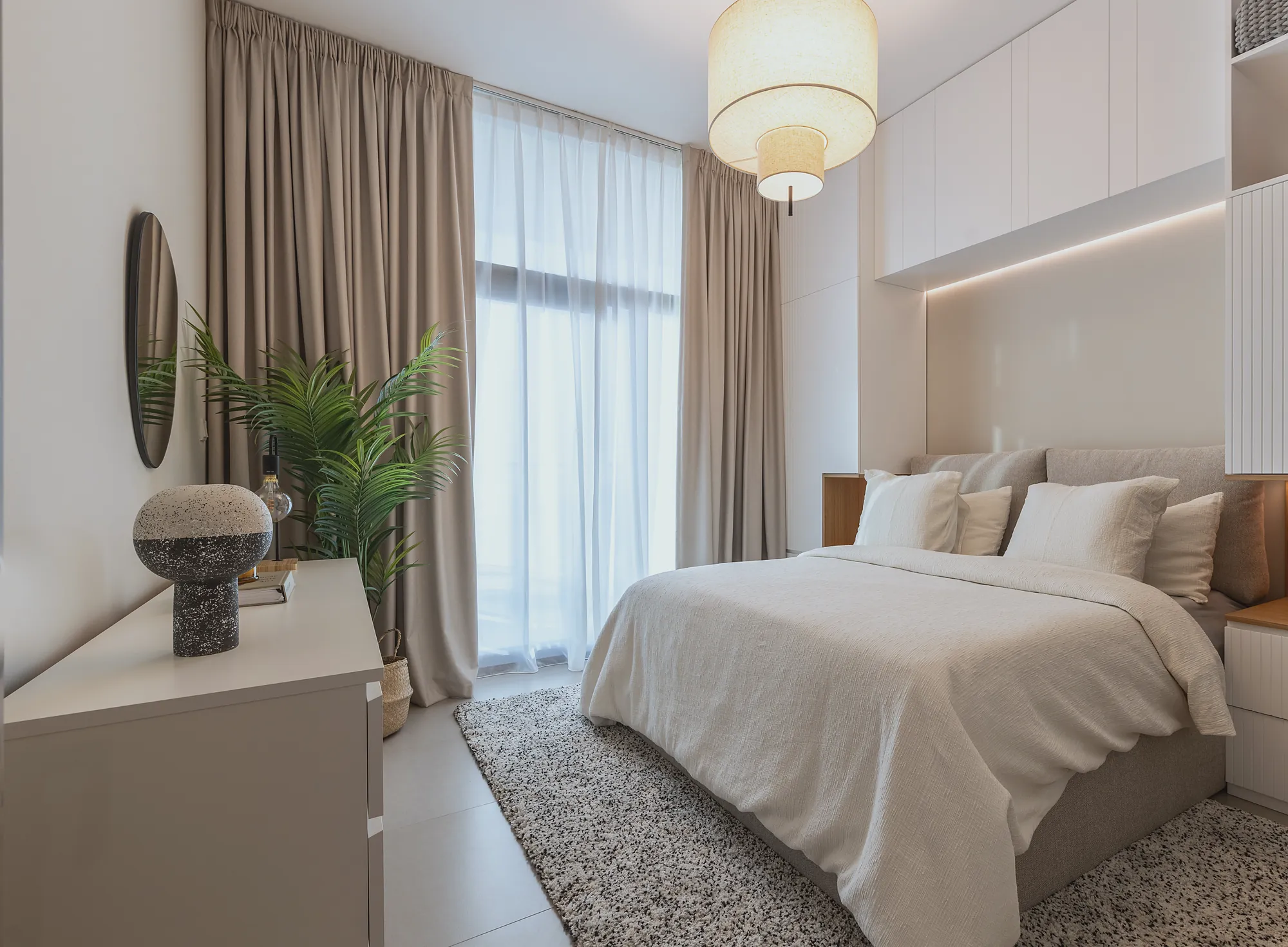 Prive 702 bedroom with built-in overhead joinery, cove lighting and linen curtains